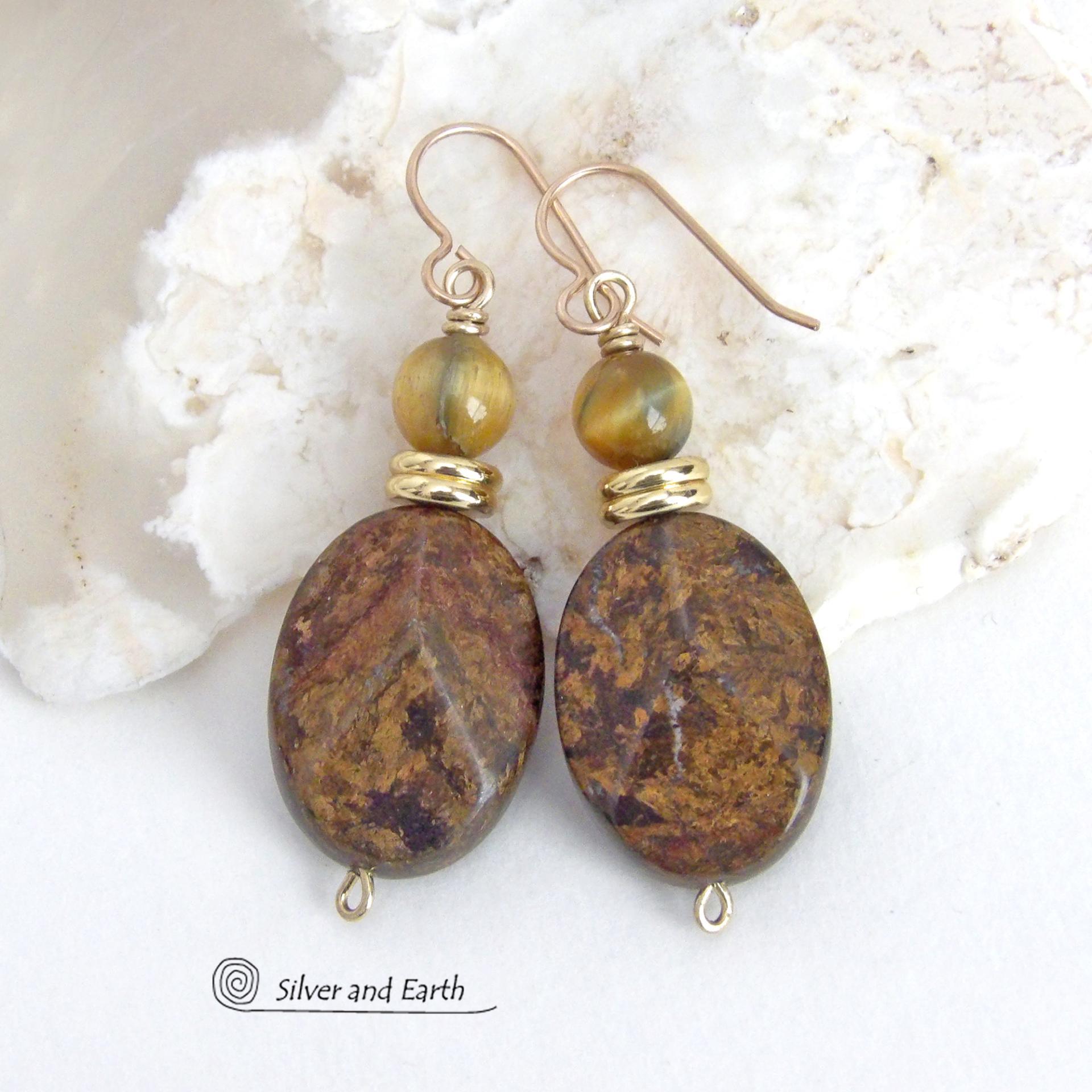 These handcrafted earrings feature natural bronzite gemstones with a faceted finish accented with golden tiger's eye gemstones and shiny brass beads. The bronzite stones have a beautiful chocolate brown hue with subtle *gold tone* metallic inclusions. Bronzite is a blend of several minerals which gives it a unique mottled appearance. They have a modern, earthy appeal and will make a great gift for a nature lover - or an interesting addition to your own jewelry wardrobe. Handmade in the USA by Silver and Ear