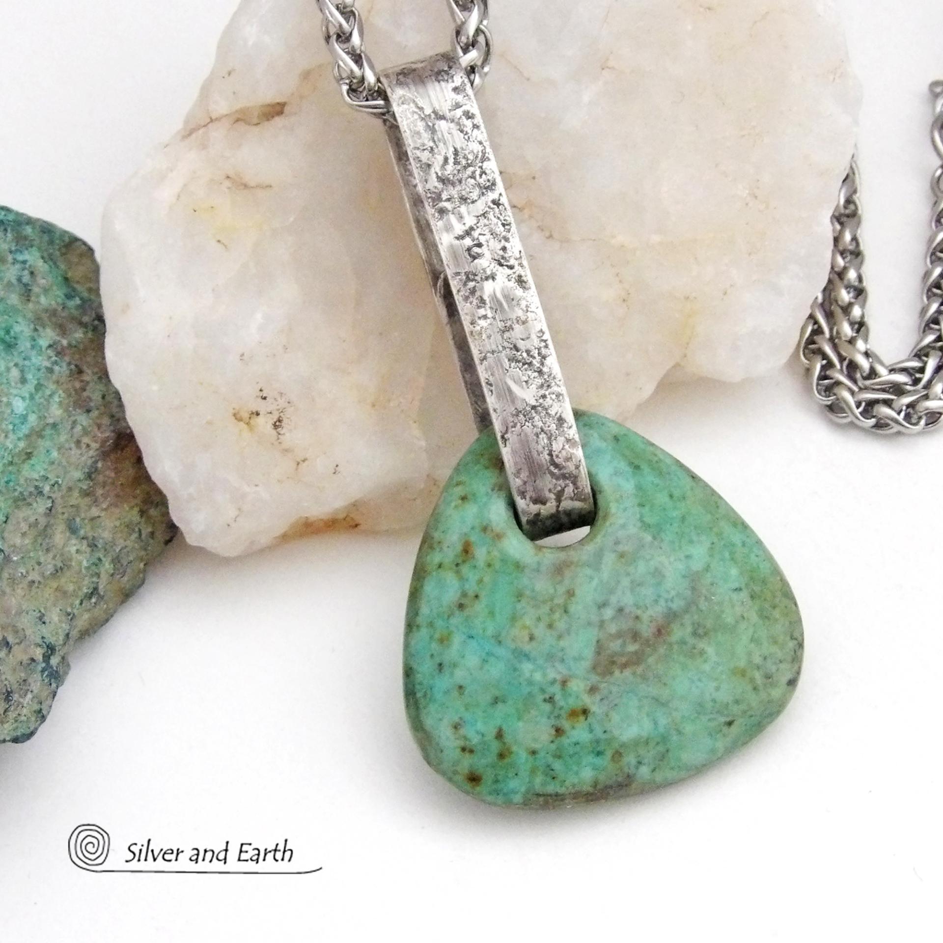 This one-of-a-kind pendant necklace features a beautiful chunky natural chrysocolla gemstone with a faceted finish. The stone is a beautiful shade of bluish-green which resembles turquoise. It hangs from a hand forged solid sterling silver bail with a lightly hammered organic texture. It's reversible. Unique and one-of-a-kind, it's sure to make a statement. Handmade in the USA by Silver and Earth Jewelry.