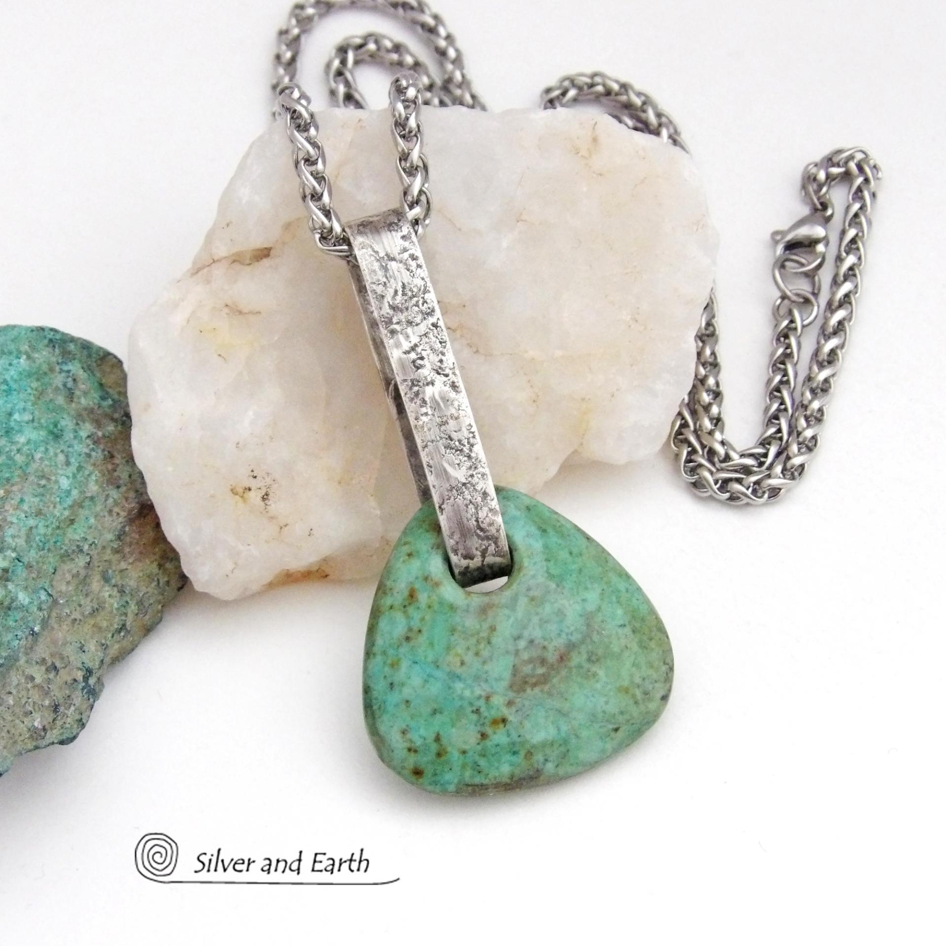 This one-of-a-kind pendant necklace features a beautiful chunky natural chrysocolla gemstone with a faceted finish. The stone is a beautiful shade of bluish-green which resembles turquoise. It hangs from a hand forged solid sterling silver bail with a lightly hammered organic texture. It's reversible. Unique and one-of-a-kind, it's sure to make a statement. Handmade in the USA by Silver and Earth Jewelry.