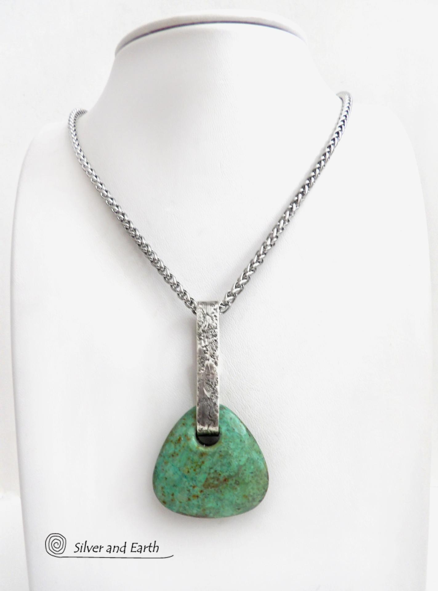 This one-of-a-kind pendant necklace features a beautiful chunky natural chrysocolla gemstone with a faceted finish. The stone is a beautiful shade of bluish-green which resembles turquoise. It hangs from a hand forged solid sterling silver bail with a lightly hammered organic texture. The pendant is reversible. (See all photos for alternate sides). Unique and one-of-a-kind, it's sure to make a statement. Makes a great gift for a natural stone lover - or a nice addition to your own jewelry wardrobe. 