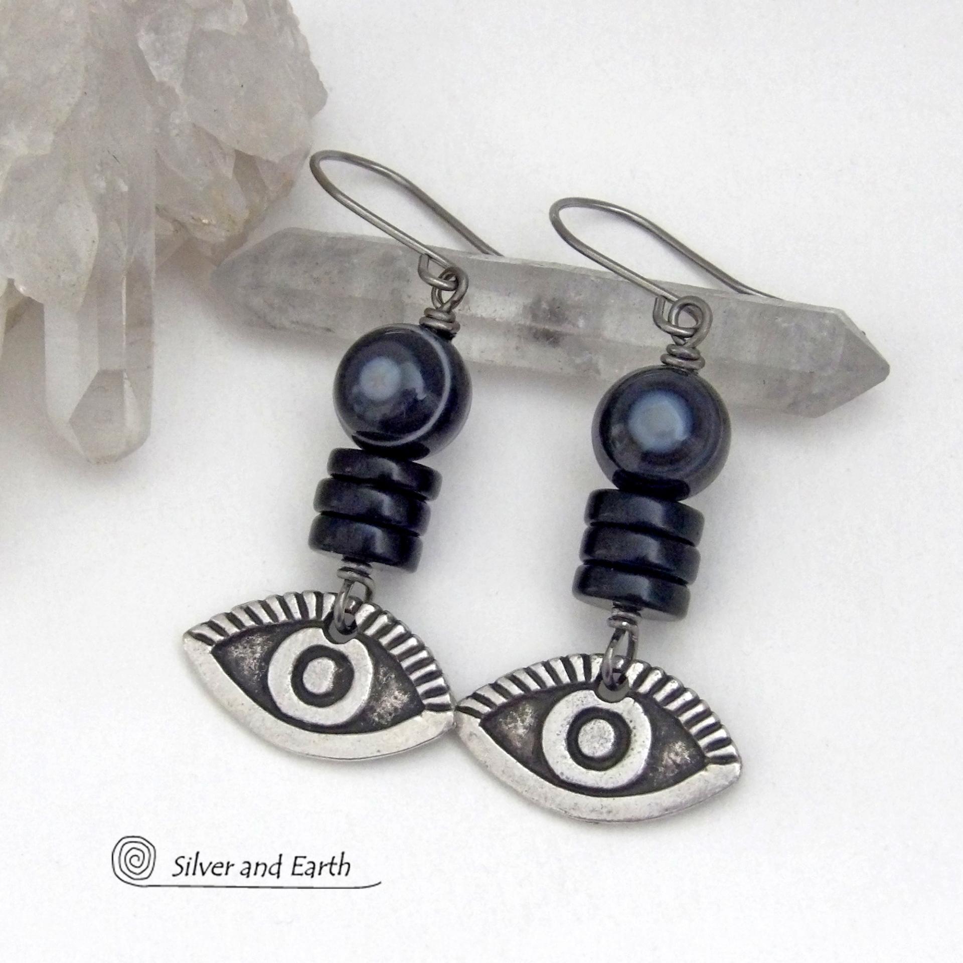 These unique earrings feature black eye agate and onyx stones accented with silver pewter "evil eye" charms. When cut at the right angle, this type of agate reveals a series of concentric rings that resembles the human eye. Evil eye symbolism has been around for centuries. The belief is that when worn -- evil eye jewelry will provide a level of protection against the envy and negative energy of others and perhaps bring the wearer good luck.