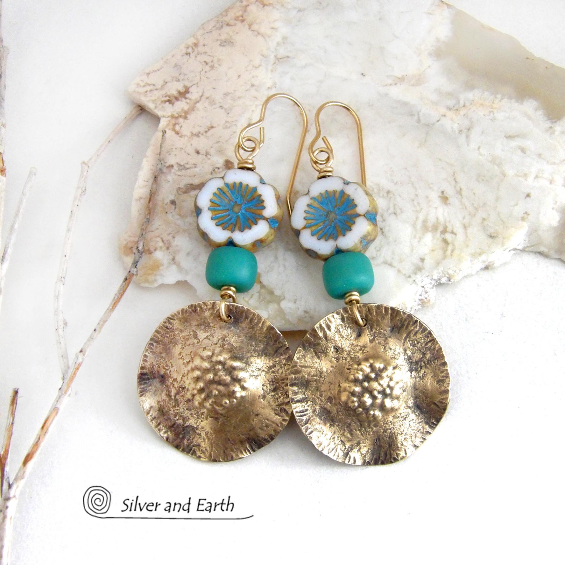 These earrings feature handcrafted gold brass dangles accented with beautifully detailed white and aqua blue Czech glass beads with gold highlights. Turquoise color glass beads were added for a pop of vibrant color. They have an earthy, modern boho feel that makes a striking statement. They'll make a great gift for a nature lover!