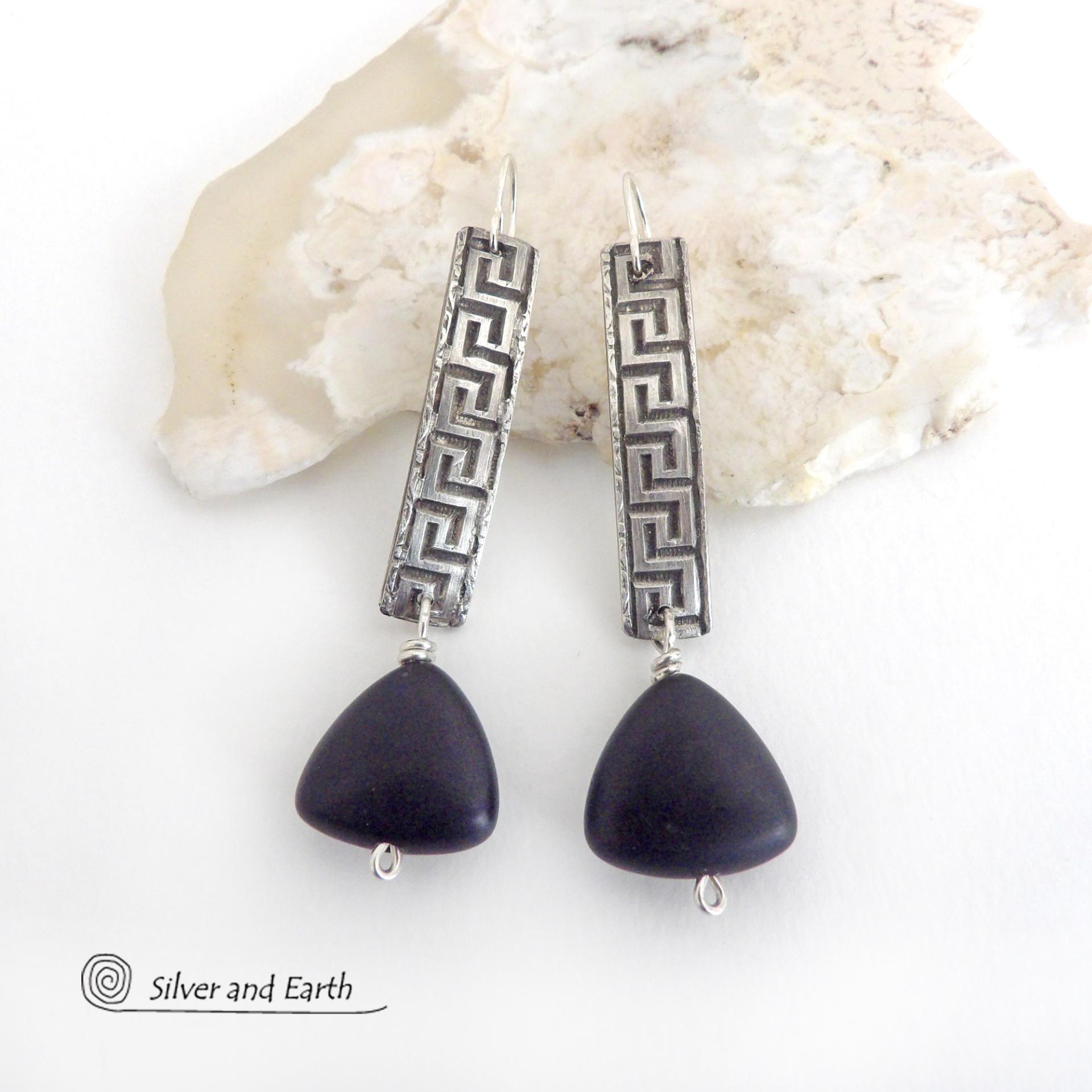 These handcrafted sterling silver earrings have a Greek key pattern and are accented with triangular-shaped black onyx stones with a matte finish. They have a contemporary modern vibe that coordinates beautifully with all wardrobe styles.Bold and unique, these earrings are perfect for women that love unusual jewelry. Handmade by SilverandEarth Jewelry.