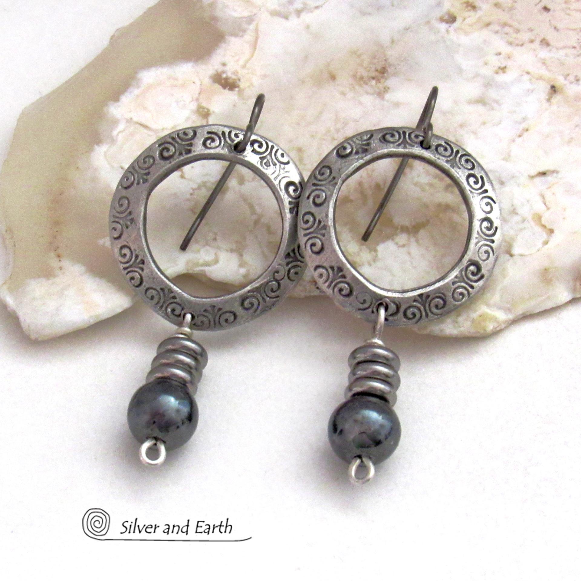 These silver pewter hoop earrings have a hand stamped texture and are accented with hematite gemstones and stainless steel beads. The stones have a metallic gray hue which cast offs a bit of natural shimmer & shine. They have a modern chic style that coordinates beautifully with all wardrobe styles. Earrings are lightweight and comfortable to wear. Handmade in the USA by Silver and Earth Jewelry. 