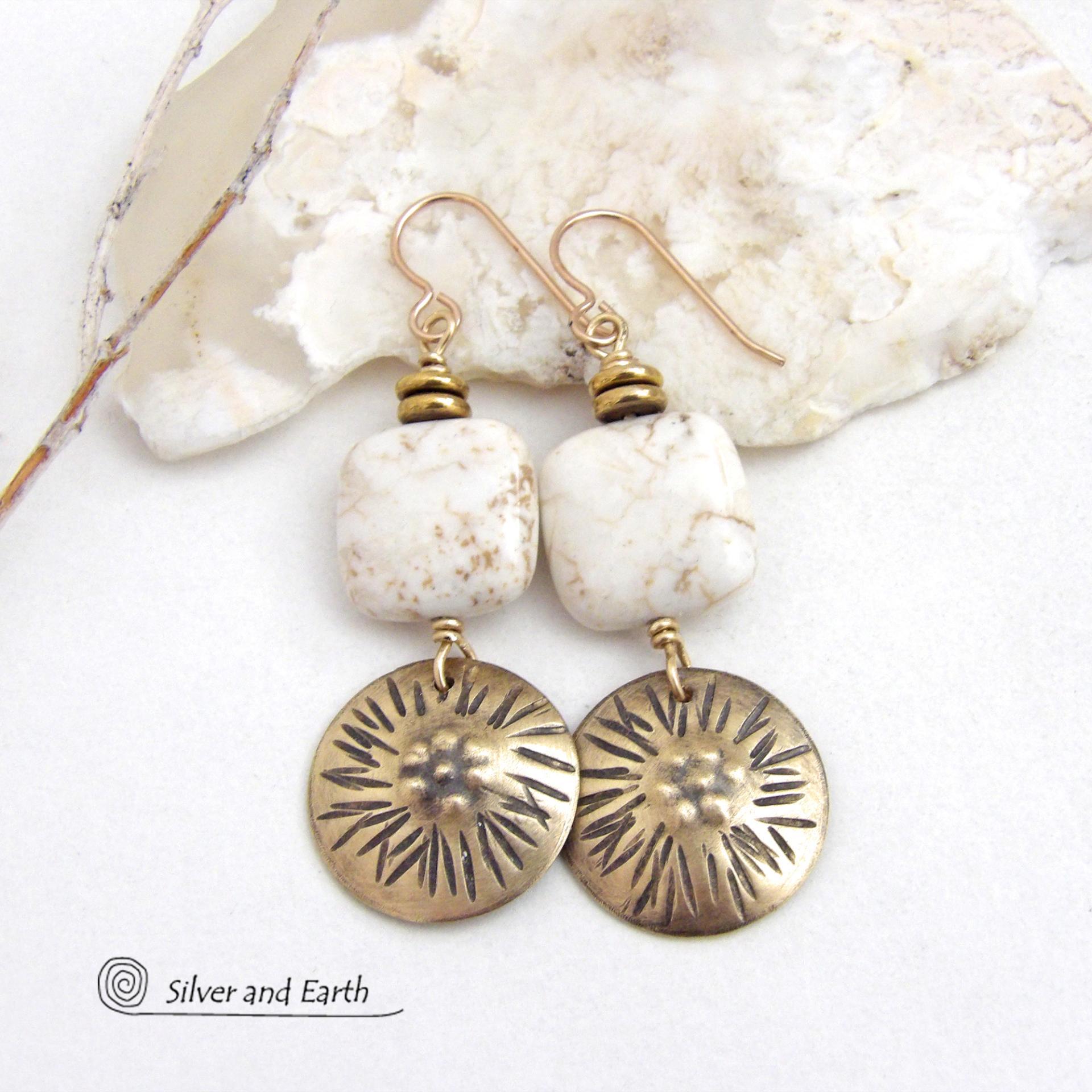 These gold brass dangle earrings have a unique hand textured design and are accented with creamy white magnesite stones. The stones have a natural matrix of golden-brown speckled inclusions and are topped off with tiny brass beads. I created the dangles out of solid gold brass sheet; and then created the texture which reminds me of the golden rays of the sun. The metal was oxidized to enhance the detail; then sealed with jeweler's wax to resist tarnishing.