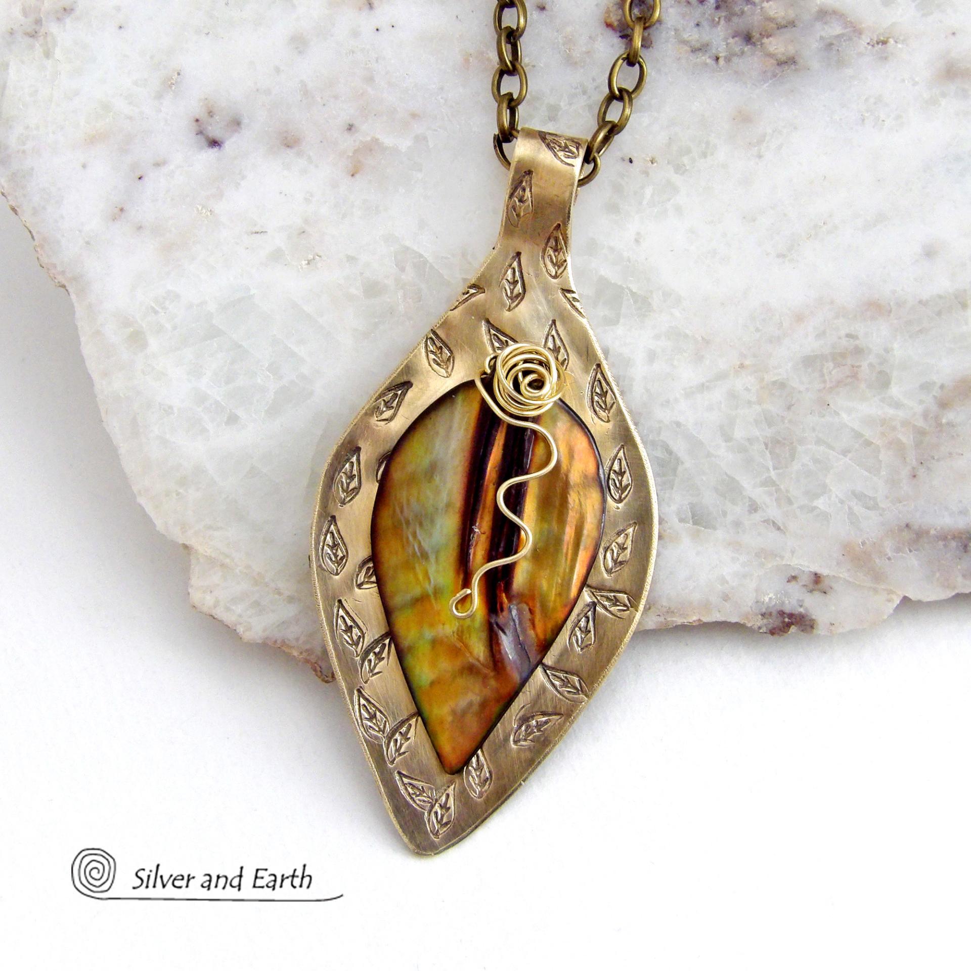 This necklace features a golden brown carved Mother of Pearl leaf accented against a handcrafted gold brass base. I hand sawed the base out of solid gold brass sheet and stamped the metal with a leaf pattern to "echo" the Mother of Pearl leaf. Unique and one-of-kind, it'll make a great gift for a nature lover - or a nice addition to your own jewelry wardrobe. It comes on an 18" antiqued brass chain with lobster claw closure. Handmade in the USA by Silver and Earth Jewelry. 
