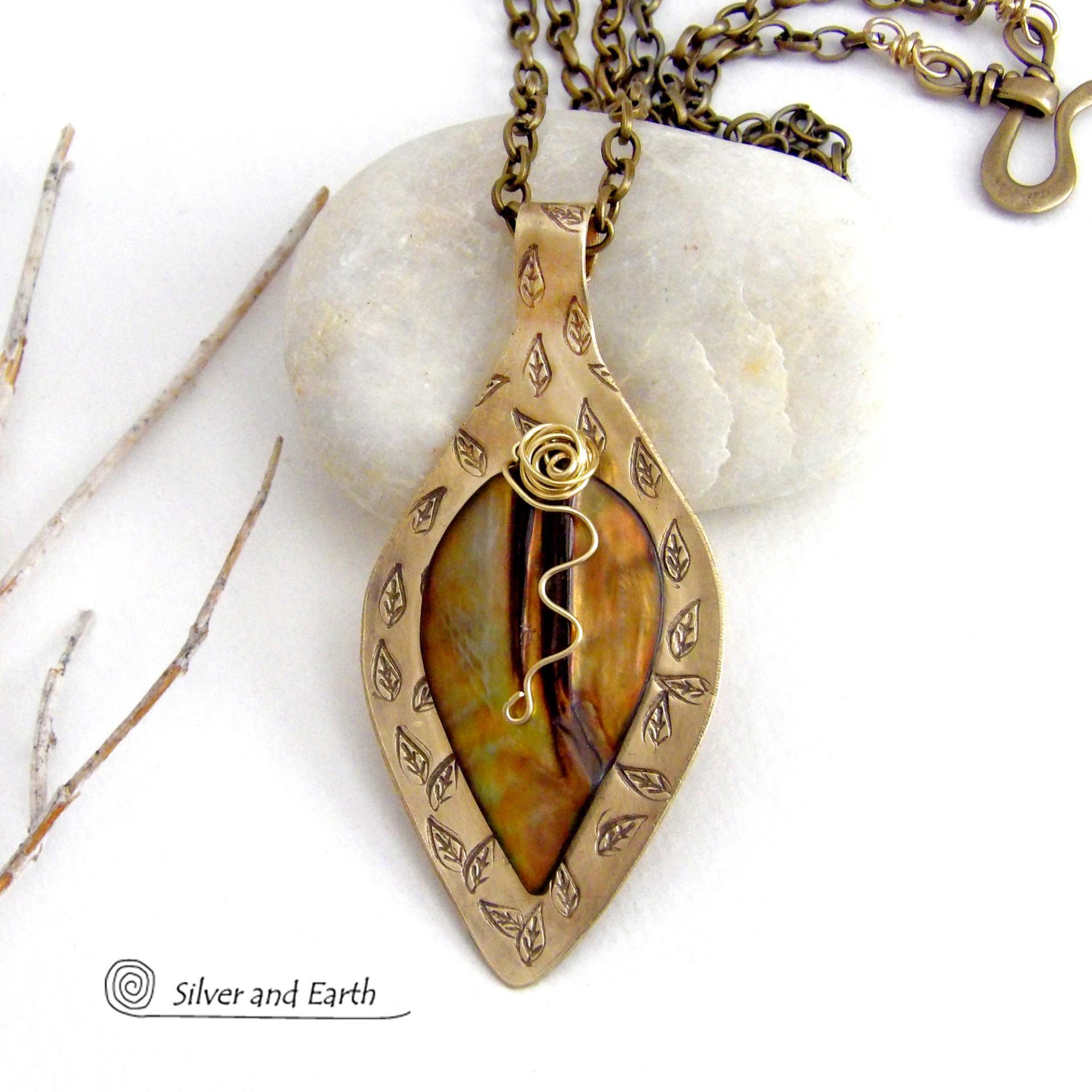This necklace features a golden brown carved Mother of Pearl leaf accented against a handcrafted gold brass base. I hand sawed the base out of solid gold brass sheet and stamped the metal with a leaf pattern to "echo" the Mother of Pearl leaf. Unique and one-of-kind, it'll make a great gift for a nature lover - or a nice addition to your own jewelry wardrobe. It comes on an 18" antiqued brass chain with lobster claw closure. Handmade in the USA by Silver and Earth Jewelry. 