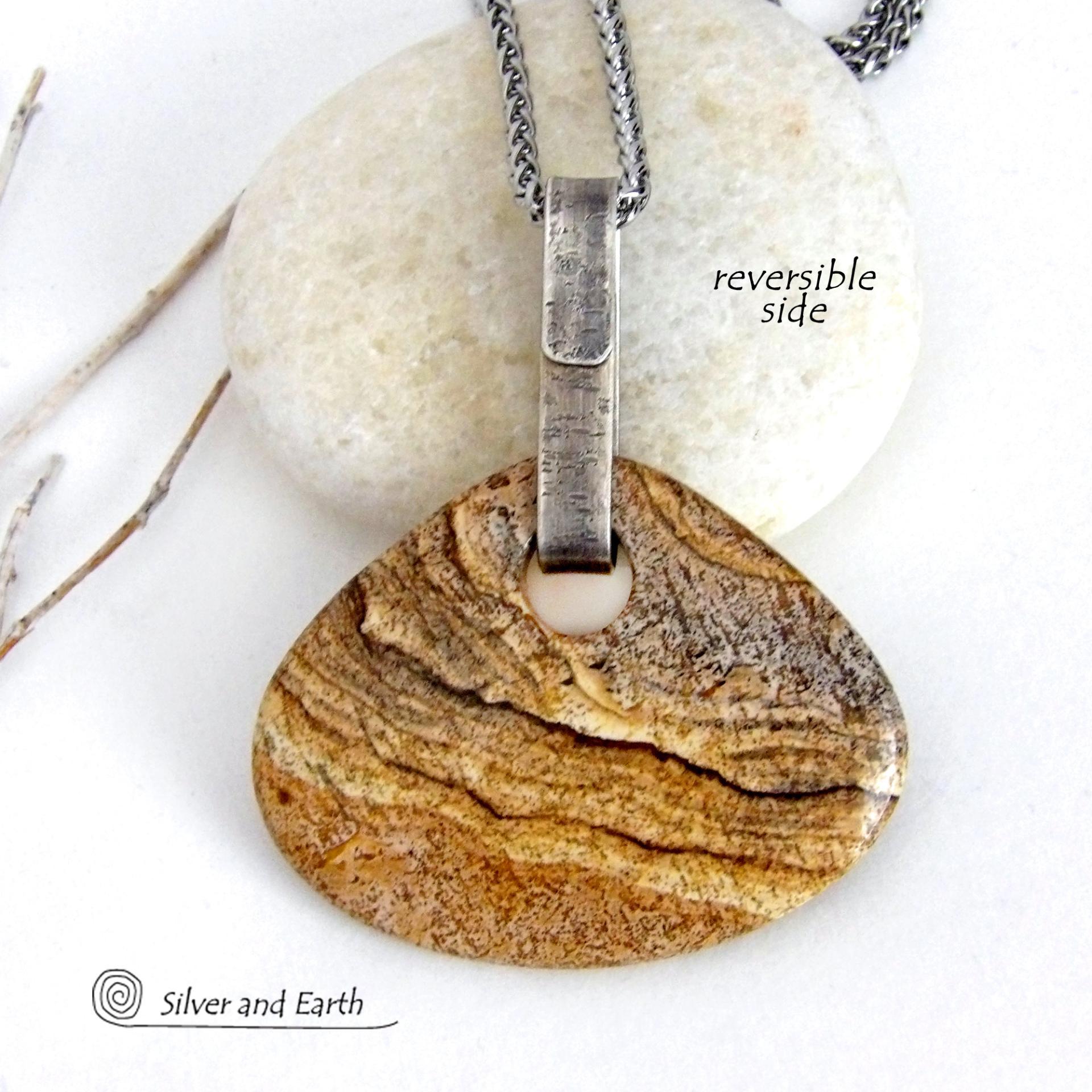 This handcrafted necklace features a large, chunky natural picture jasper stone accented with a handcrafted sterling silver bail. The stone has a beautiful natural pattern in various shades of brown, beige and gray. Big and bold, this necklace is a real one-of-a-kind statement piece - perfect for anyone that loves natural stones! It's reversible and can be worn on either side. Coordinating earrings sold separately. Handmade in the USA by Silver and Earth Jewelry.