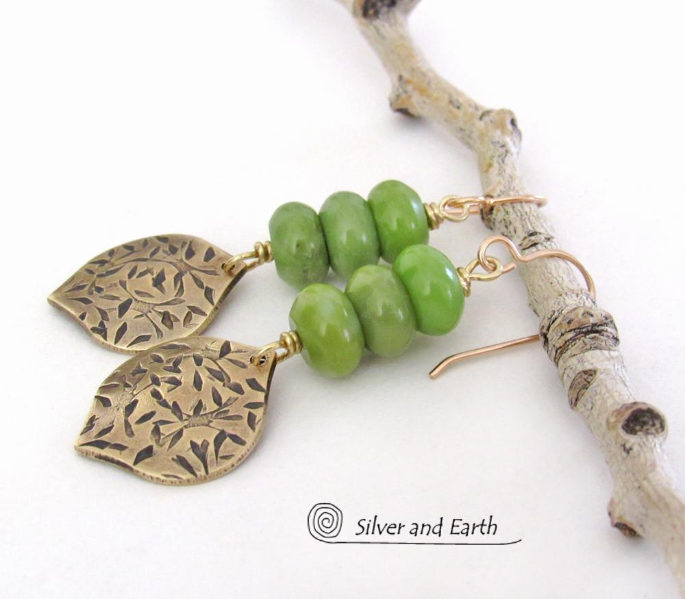 These handcrafted earrings feature gold brass dangles with a hand stamped texture accented with a stack of green serpentine gemstones. They have an earthy chic, modern style that coordinates well with all wardrobe types.These artisan-made earrings are perfect for adding a touch of earthy modern style to any outfit.  