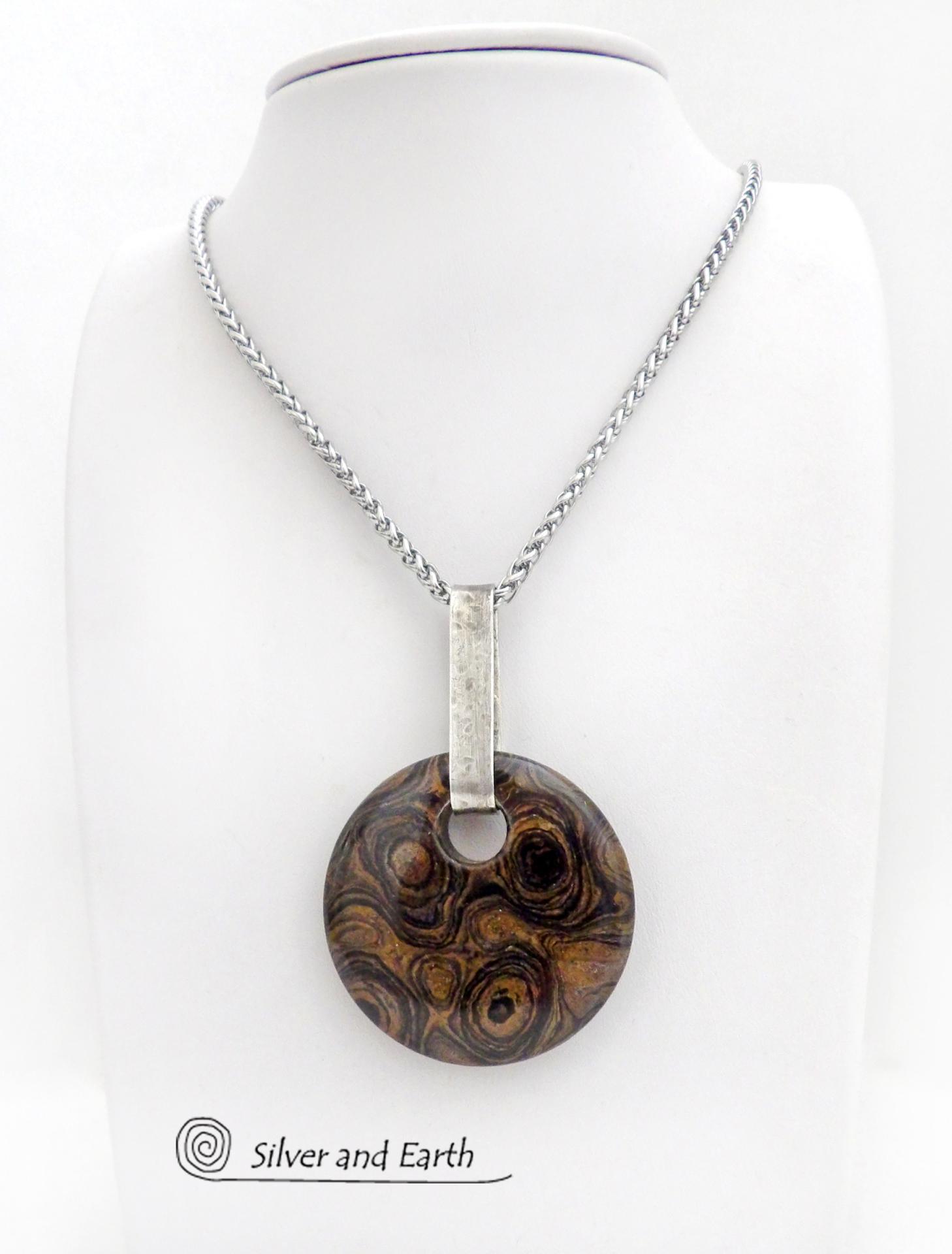 This one-of-a-kind necklace features a natural stromatolite fossil stone accented with a hand forged sterling silver bail with a lightly hammered organic texture. Stromatolites are fossilized layered deposits of algae within ancient sedimentary rock. These old single-celled organisms are believed to be some of the first forms of life on this planet.