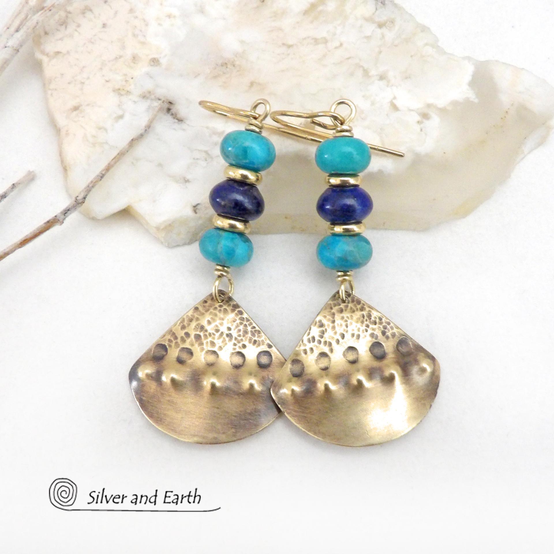 These handcrafted gold brass earrings have a unique hand textured design and are accented with a stack of blue lapis lazuli and turquoise gemstones separated with small brass beads. These handcrafted earrings showcase a unique blend of textures, colors and patterns, perfect for adding a touch of bohemian style to any outfit. 