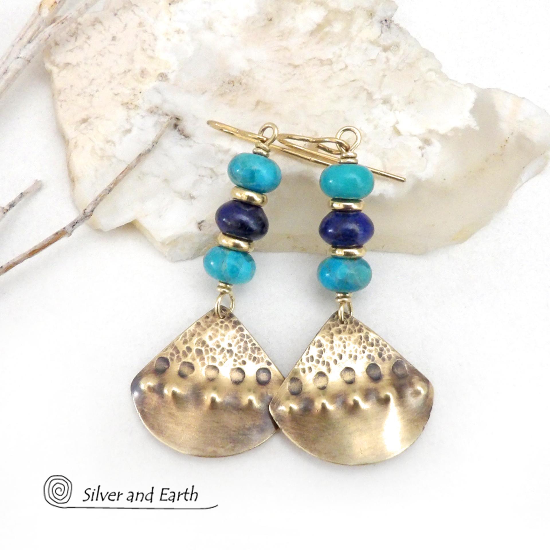 These handcrafted gold brass earrings have a unique hand textured design and are accented with a stack of blue lapis lazuli and turquoise gemstones separated with small brass beads. They have a modern style with a boho chic flair that will make a unique statement. Silver and Earth is a small business that makes handmade jewelry and who is known for her unique exclusive designs. 