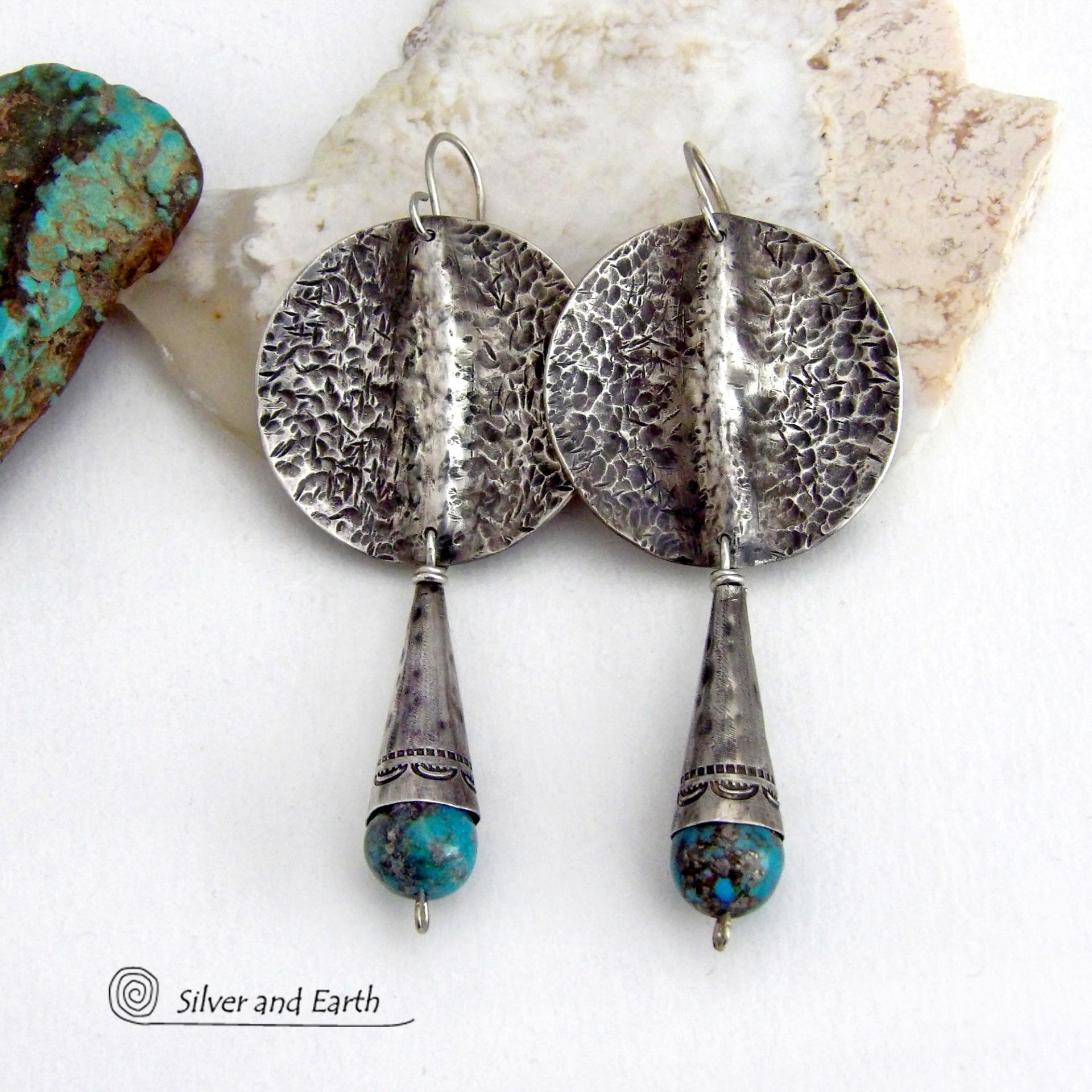 Big and bold - these handcrafted sterling silver earrings have an earthy, organic design with an edgy, modern southwest style. They feature solid sterling silver with a rustic, hammered texture and a dark oxidized finish. They are accented with hammered and hand stamped sterling silver cones and natural turquoise stone beads. Perfect for women that love to wear bold organic looking jewelry with a subtle southwest style and flair. Handmade in USA by Silver and Earth, a New Mexico True Certified Business.