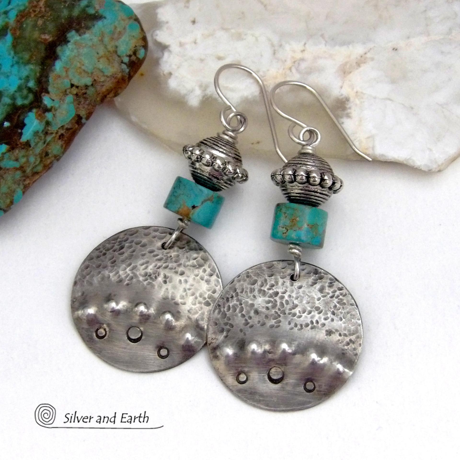 These handcrafted earrings feature uniquely textured hammered and hand stamped sterling silver accented with natural turquoise stones and silver plated beads. Bold and striking, they have a modern, southwest style with a touch of tribal flair. Handmade in the USA by Silver and Earth Jewelry. 