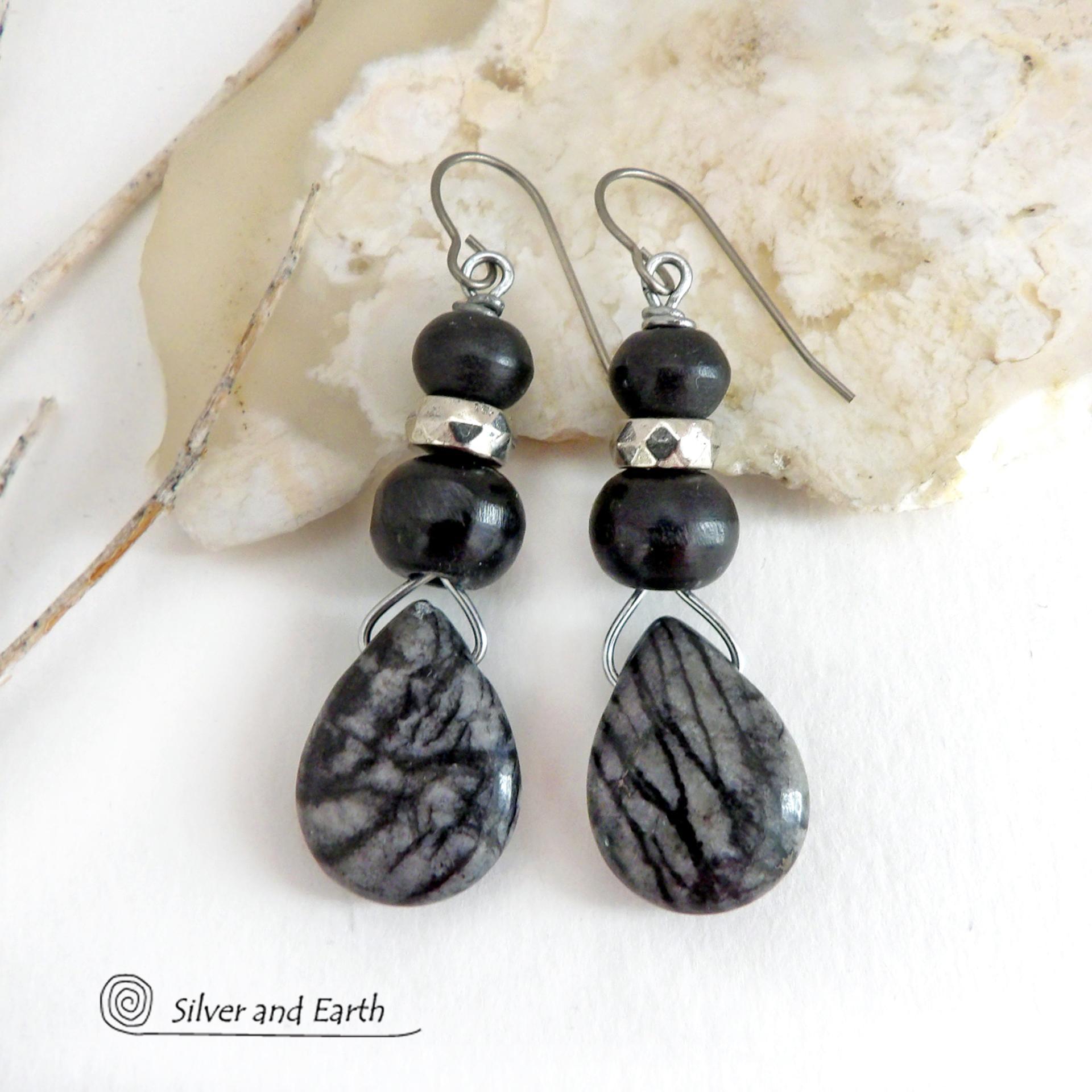 The earrings feature natural zebra jasper stones accented with black beads and silver plated beads and dangle from hypoallergenic titanium ear wires. This stone is known as zebra jasper because of the natural striped matrix that resembles a zebra's pattern. It's a striking stone with earthy hues of soft gray, along with streaks of black. They'll make a great gift for a natural stone lover - or a nice addition to your own jewelry wardrobe. Handmade in the USA by Silver and Earth Jewelry. 