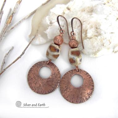 These handcrafted copper earrings have a bold, ethnic African style and flair. They feature round copper dangles with a rustic hammered texture accented with African etched giraffe print agate stones topped off with solid copper beads. Unique and striking, they'll make a bold statement. Perfect for women that love ethnic tribal style jewelry. Handmade in the USA by Silver and Earth Jewelry. 
