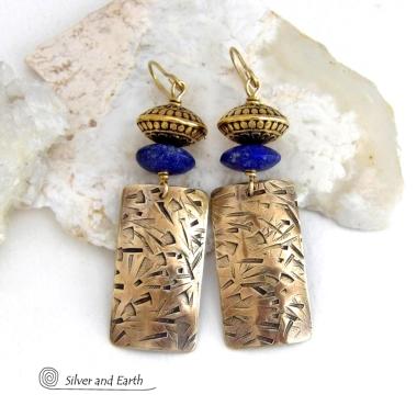 These earrings feature handcrafted brass rectangle dangles with a hand stamped texture accented with matte lapis lazuli gemstones and brass tribal style beads. They have an elegant modern style with boho chic flair that coordinates beautifully with all wardrobe styles. Perfect for women that love to wear unique artisan handcrafted jewelry. Handmade in the USA by Silver and Earth Jewelry.