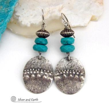 These handcrafted earrings feature sterling silver oval dangles with a hammered and hand stamped texture accented with faceted natural turquoise gemstones and oxidized sterling silver beads with a rich, corrugated texture and oxidized finish. They have a modern, southwestern style and are perfect for women that love to wear artisan handcrafted southwestern jewelry. Handmade in the USA by Silver and Earth jewelry, a New Mexico True Certified business. 